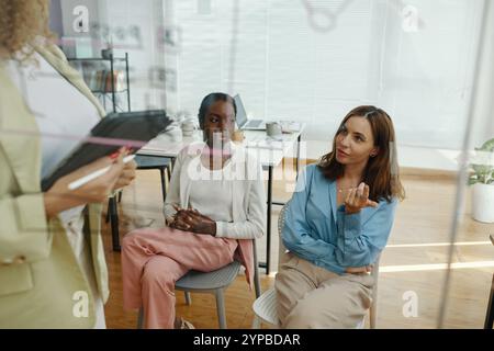 Discussing Business Strategy with Team in Modern Office Stock Photo