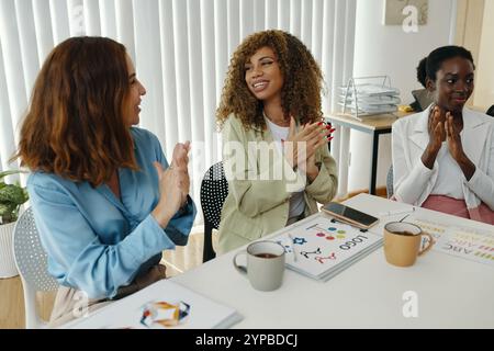 Women in Office Engaging in Collaborative Discussion Stock Photo