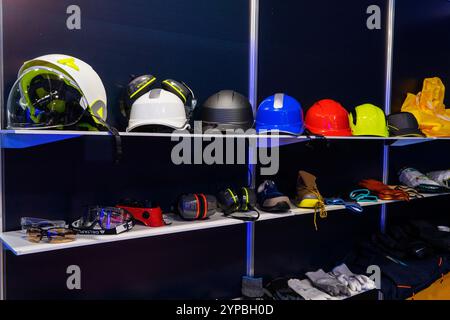 Multi-colored protective helmets for engineers, builders, workers of the oil and gas industry, for handymen in the shop window, at exhibitions. Compli Stock Photo