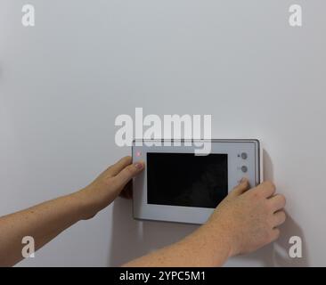 Technical maintenance and setup of a Home Intercom System Stock Photo