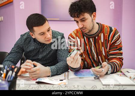 Two male students learning together at language school Stock Photo