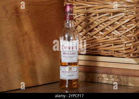 bottle of Dewar's blended scotch whisky, white label, double aged, double cask matured, on a rustic background with copy space Stock Photo