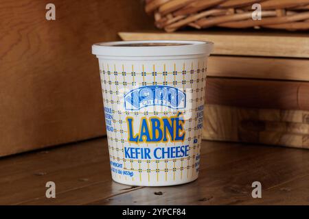 package of Victor's Cheese brand Labne Kefir cheese, a mediterranean fermented dairy spread, on a rustic backaground with copy space Stock Photo