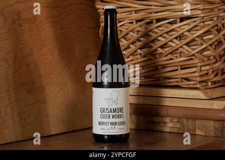 bottle of Grisamore Cider Works hard or alcoholic apple cider on a rustic background with copy space Stock Photo