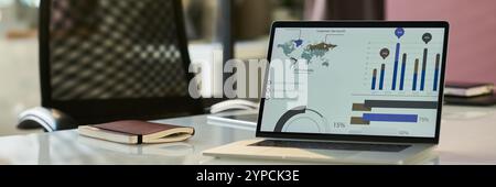 Header of charts and diagram on screen of laptop standing on workplace of modern economist or other business specialist in office Stock Photo