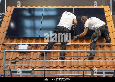 Presentation of the rapid installation of a solar system on a residential house with a pitched roof, in the form of a competition, European Solar Game Stock Photo