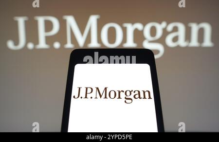 April 9, 2024, Brazil. In this photo illustration, the JPMorgan logo is displayed on a smartphone screen and in the background Stock Photo