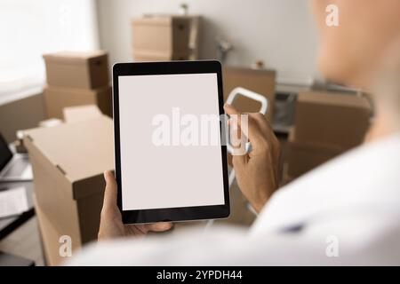 Internet shop manager using tablet computer in storage room Stock Photo