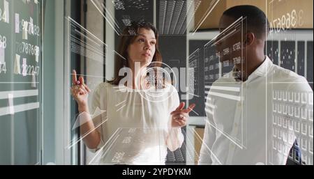 Analyzing data on screen, business professionals with futuristic interface image Stock Photo