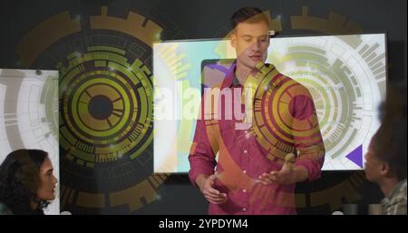 Presenting in meeting room, man with digital interface image over screen and colleague Stock Photo