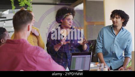 Discussing ideas, diverse team collaborating over image of graphs and charts Stock Photo