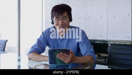 Front view of Asian male executive interacting in the office Stock Photo