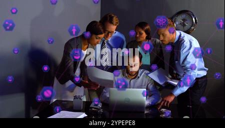 Business team collaborating over laptop with data processing image Stock Photo