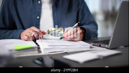 Auditor Using Magnifying Glass For Audit And Fraud Investigation Stock Photo