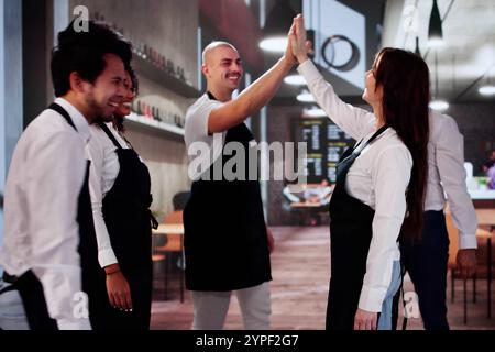 Happy Successful Store Team Giving High Five And Celebrating Stock Photo