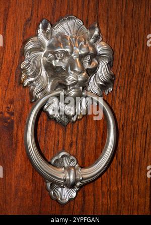 ornate door knocker in the shape of an animal a bit of antique before they had doorbells. Stock Photo