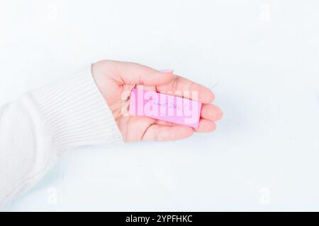 On the palm of a young woman is a handwritten note reading Thank you. Copy space. Stock Photo