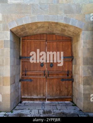 The wooden doors with intricate metal fittings stand proudly at the Courtyard of the Palace of the Shirvanshahs at the Old City, or Icherisheher, in Baku, Azerbaijan Stock Photo