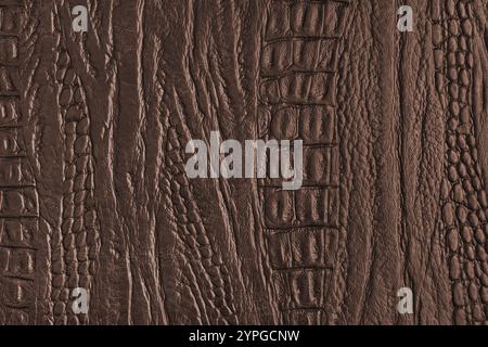 Crocodile genuine leather structure texture macro, brown colored leatherette surface with metallic, pearlescent effect. Reptile skin close up, macro b Stock Photo