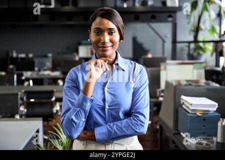 Young confident business woman executive standing in office looking at camera. Stock Photo