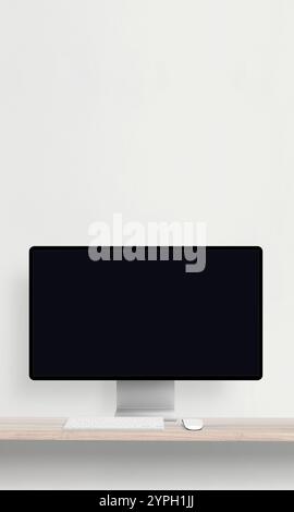 Desktop monitor with a blank screen on a desk featuring a keyboard and mouse, perfect for mockup presentations of websites Stock Photo