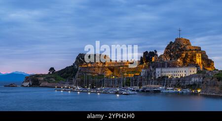 Morning twilight at Mandraki harbour in front of the Old Venetian Fortress, Corfu, Greece Stock Photo