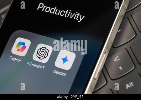 New York, USA - November 26, 2024: AI mobile bots app icons  on screen in keyboard button background close up view Stock Photo