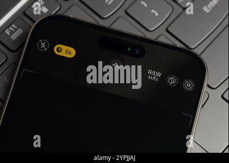 New York, USA - November 26, 2024: Iphone camera menu on screen in keyboard button background close up view Stock Photo