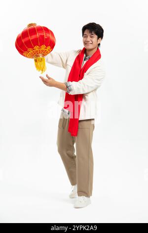 Young Asian man holding Chinese red lantern Stock Photo