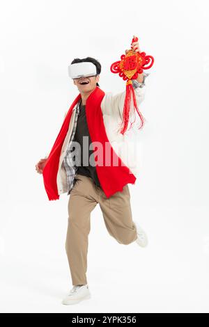 Young Asian man wearing VR glasses and holding FU Stock Photo