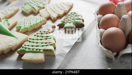 Freshly baked Christmas tree cookies decorated with green icing Stock Photo