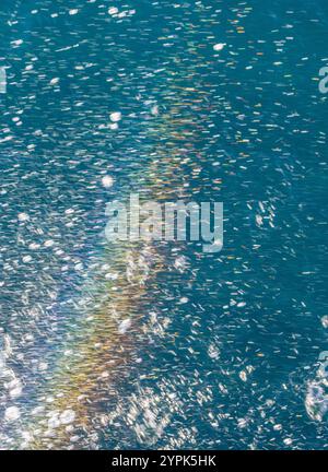 Splashing ocean water. Abstract colorful water rainbow background Stock Photo