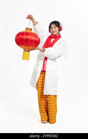 woman wearing a windbreaker and holding a Chinese lantern Stock Photo
