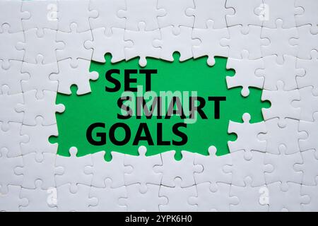Set smart goals symbol. Concept words Set smart goals on white puzzle. Beautiful green background. Business and Set smart goals concept. Copy space. Stock Photo