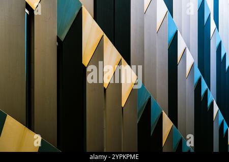 Abstract Colorful Architectural Facade with Interplay of Light, Shadows, and Angular Geometric Patterns Stock Photo
