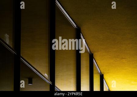 Abstract View of Modern Architecture with Bold Yellow Walls and Reflective Glass Panels Stock Photo
