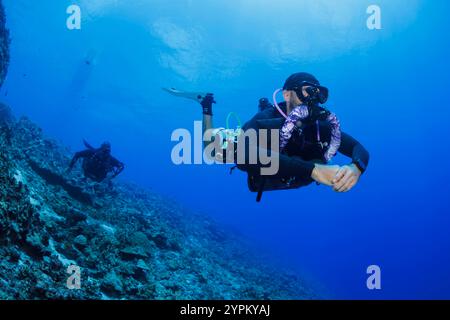 Two technical rebreather divers (MR) descending off the island of Saipan, Northern Mariana Islands, Micronesia. Stock Photo