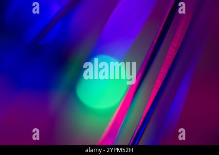 Green and blue spots of light through strings of light in an abstract background Stock Photo