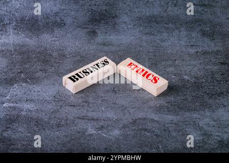 Business ethics symbol. Concept word Business ethics on wooden blocks. Beautiful grey background. Business and Business ethics concept. Copy space Stock Photo