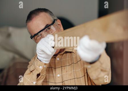 Senior Handyman Working In Workshop Stock Photo