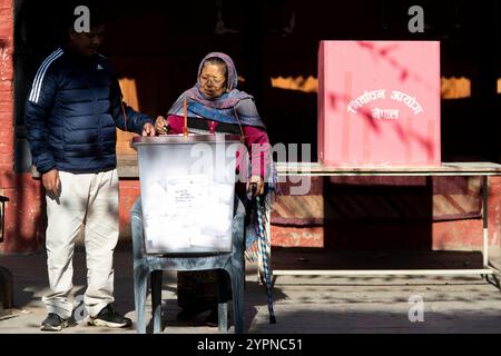 On December 1, 2024, in Kathmandu, Nepal. A elderly women casts her vote at the polling station during Nepal's local by-election. According to the Election Commission of Nepal, a total of 44 vacant seats are available for contest across the country. (Photo by Abhishek Maharjan/Sipa USA) Credit: Sipa USA/Alamy Live News Stock Photo