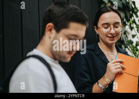High school students working on homework together outdoors after class Stock Photo
