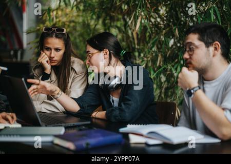 High school students collaborating on assignments in a cozy coffee shop Stock Photo