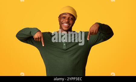Look At This. Excited Black Guy Pointing Down With Two Hands Stock Photo