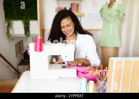 Creative designer working on a sewing project in a vibrant office space Stock Photo