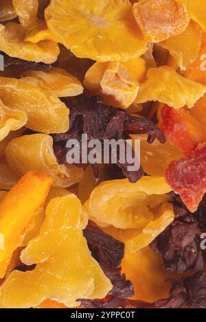 Mix of dried exotic fruit, mangos,slices of pineapples, passion fruit, papaya. Vegetarian dessert. Stock Photo