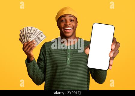 Cheerful Young Black Man Holding Smartphone With Blank Screen And Holding Cash Stock Photo