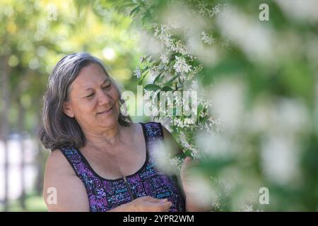 portrait of senior south America native  woman in her garden by her house  on sunny summer   day Stock Photo