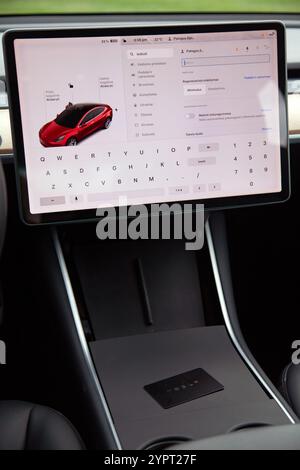 Vilnius, Lithuania - 16-08-2024 -  View inside of Tesla Model 3, huge dispay and car key Stock Photo