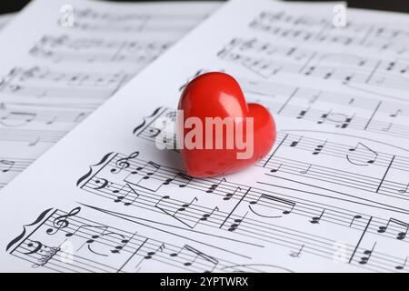 Heart figure on musical note sheets, closeup Stock Photo